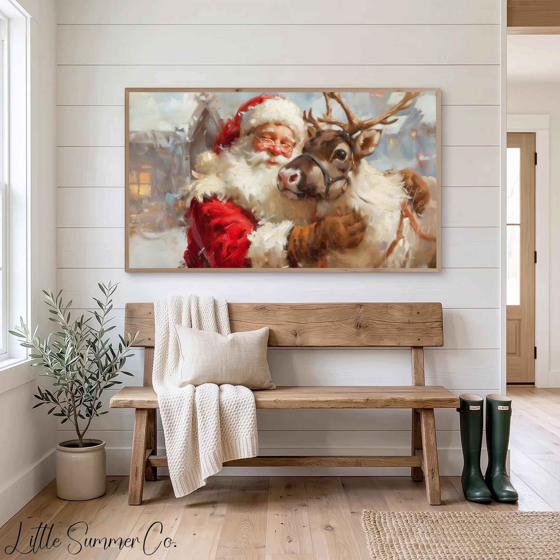Santa Hugging a Reindeer Frame TV Art displayed on a TV